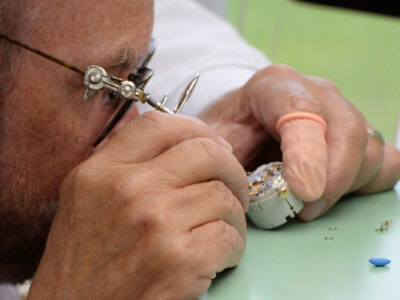 Watchmaker repairing a watch