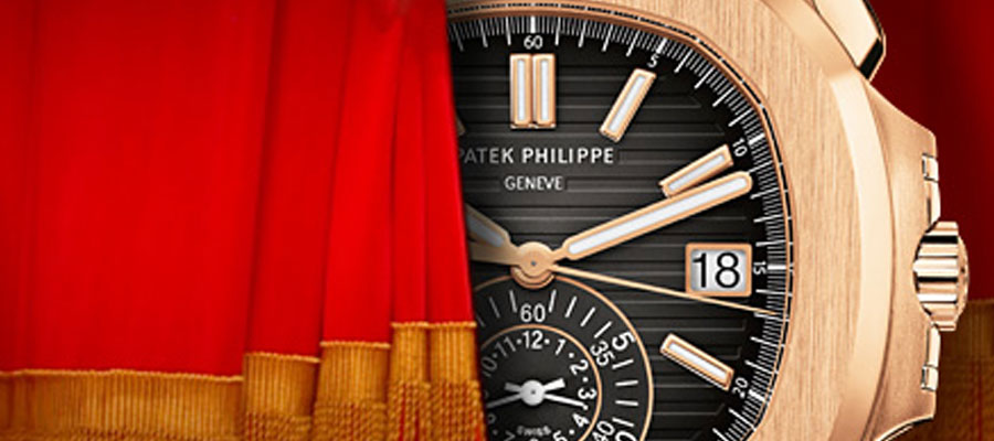 Blog-Patek-curtain Patek watch peaking out of a red curtain