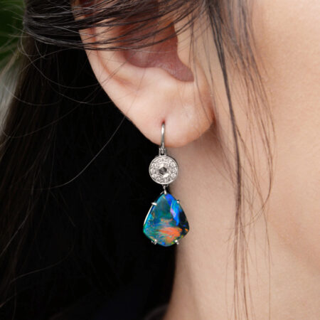 Broad flash Opal Earrings on ears